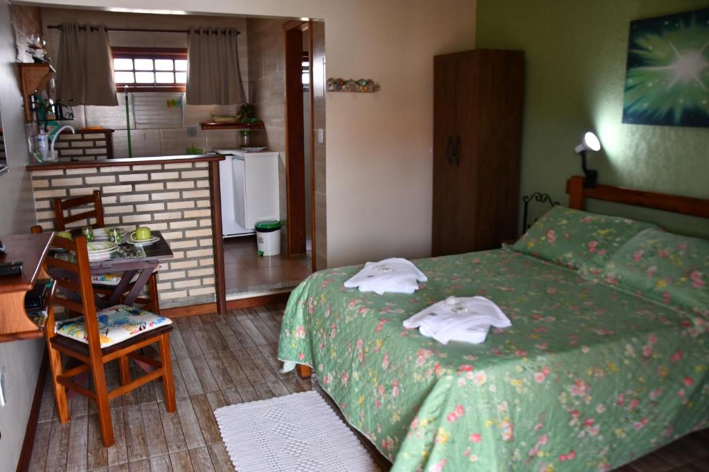 阿拉亚尔-杜卡布Estúdio Recanto Dos Anjos的一间卧室配有一张床,上面有两条毛巾