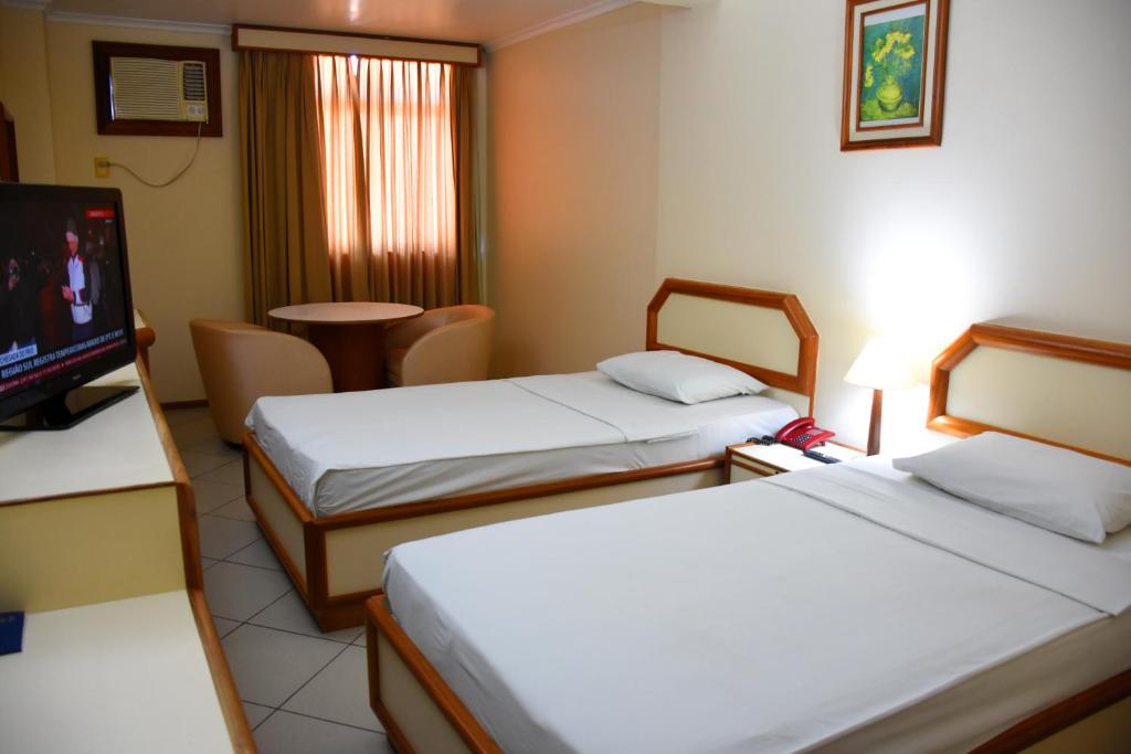 Hotel Grão Para客房内的一张或多张床位