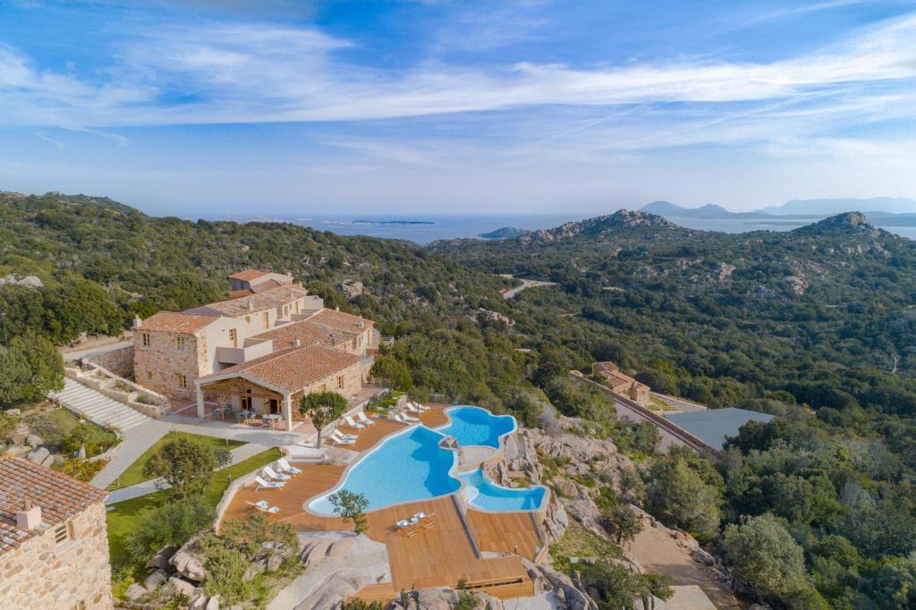 阿尔扎凯纳Hotel Borgo Smeraldo的享有带游泳池的房屋的空中景致