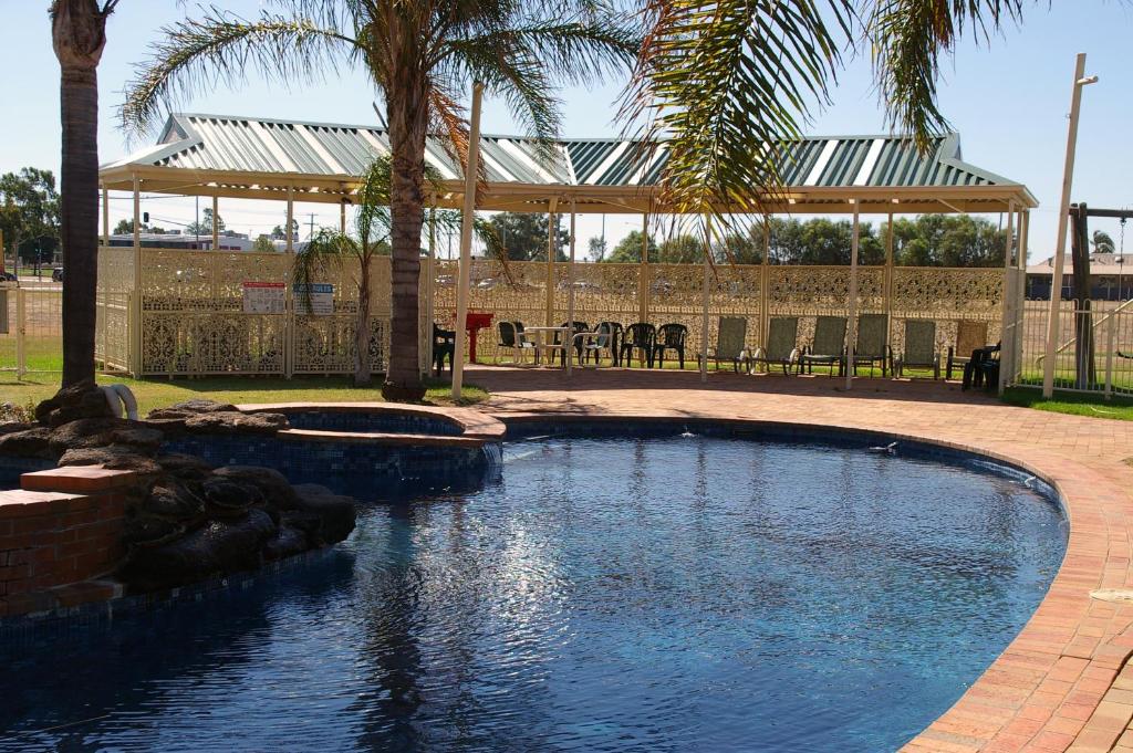 谢珀顿松树乡村俱乐部汽车旅馆的一个带凉亭和棕榈树的游泳池