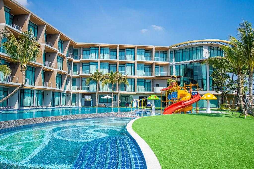 七岩Elmas Cha Am Design Hotel的一个带滑梯和游乐场的度假游泳池