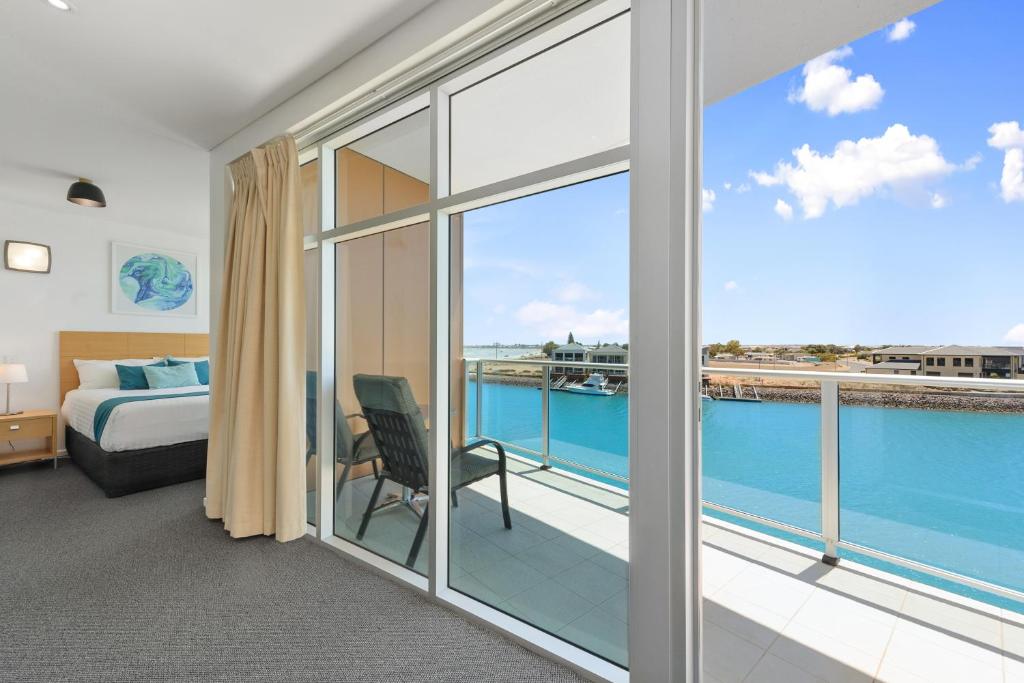 沃拉鲁Wallaroo Marina Sea Vu Apartment的一间卧室设有一张床和一个美景阳台