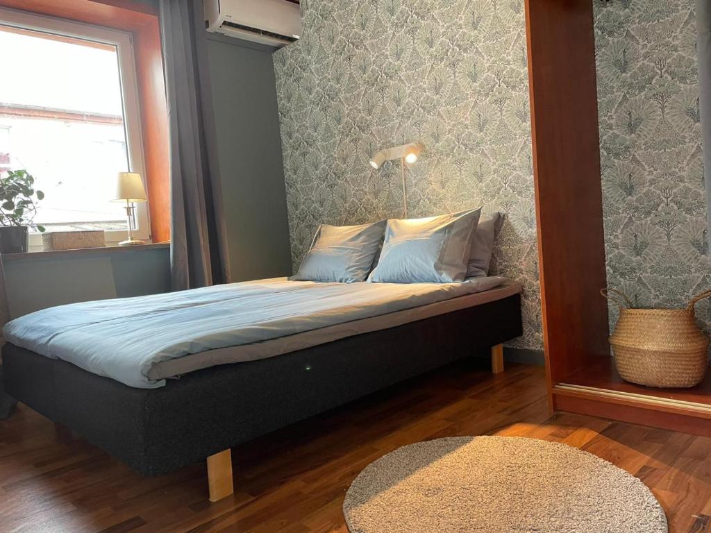 OxieRymlig lägnhet med 2 sovrum的卧室配有一张壁挂镜子的床