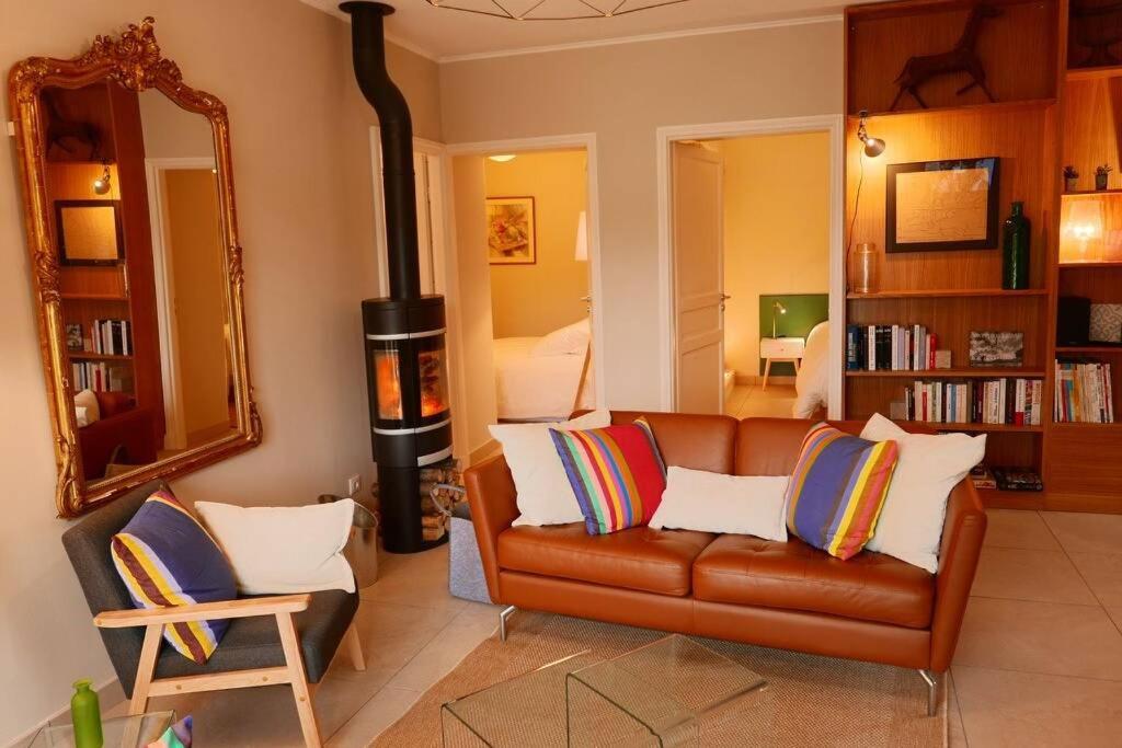Eyzin-PinetLe Hameau du Buron - "Le Petit Buron" - Option SPA的带沙发和燃木炉的客厅