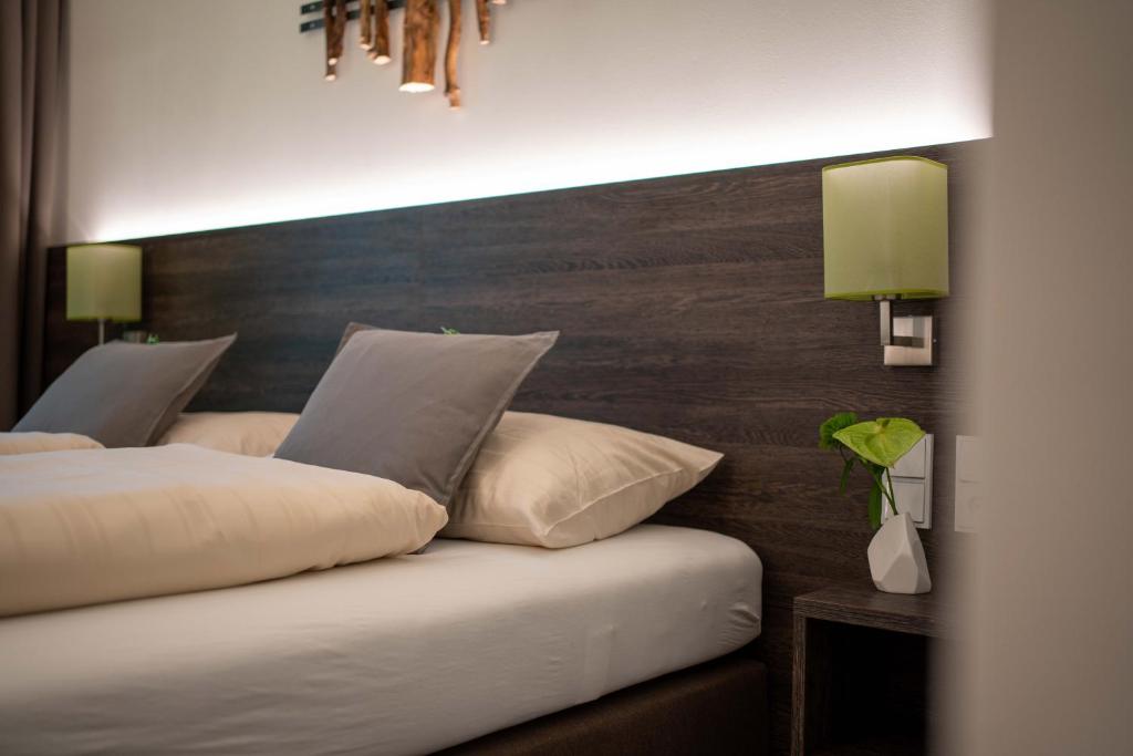 Gunskircheneee Hotel Gunskirchen的一间卧室设有两张床和木制床头板