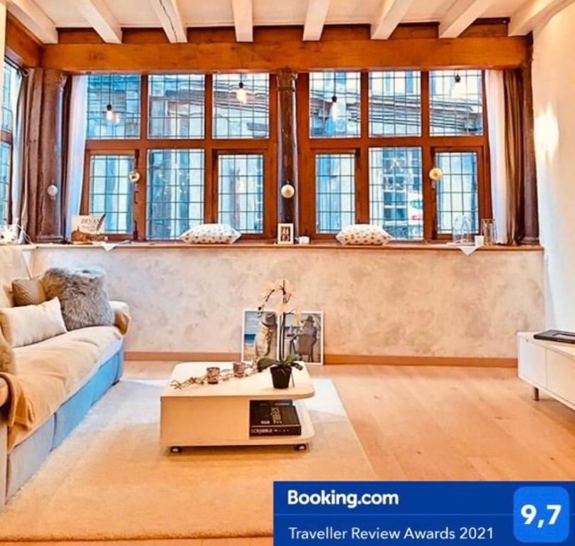 迪南Appartement de charme classé 4 étoiles coeur historique de Dinan的客厅配有沙发和桌子