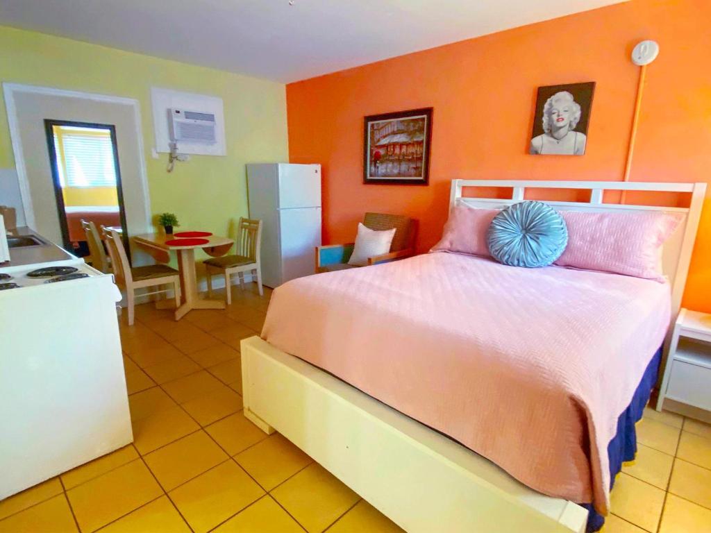 圣徒皮特海滩Bella Sirena Inn的一间卧室配有一张带橙色墙壁的大床