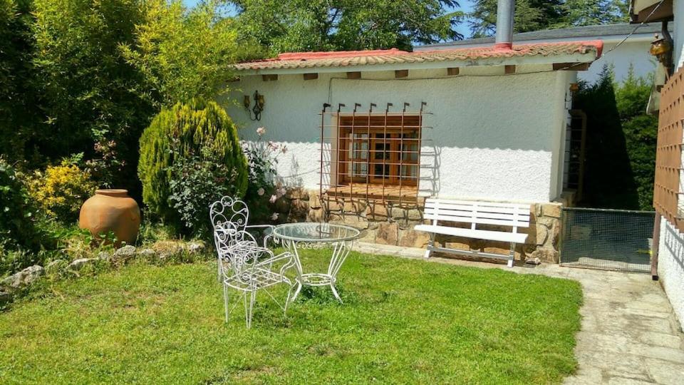 索托德尔雷亚尔La Casita de Chozas的一个带房子的院子内的一张桌子和两把椅子