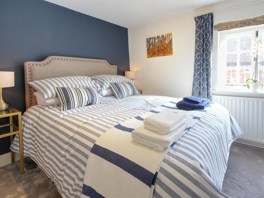 法纳姆卡特雷夫度假屋的一间卧室配有带毛巾的床