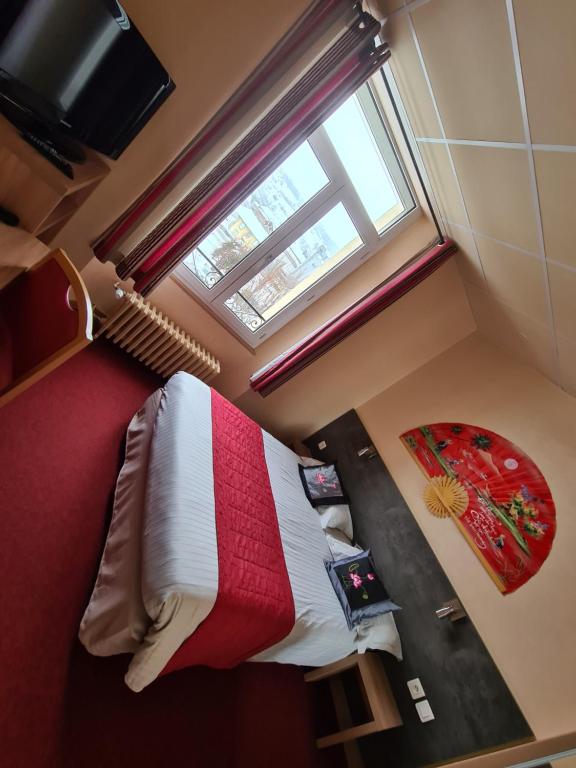 米拉HOSTELLERIE du CANTAL的一间卧室配有一张带红白毯子的床