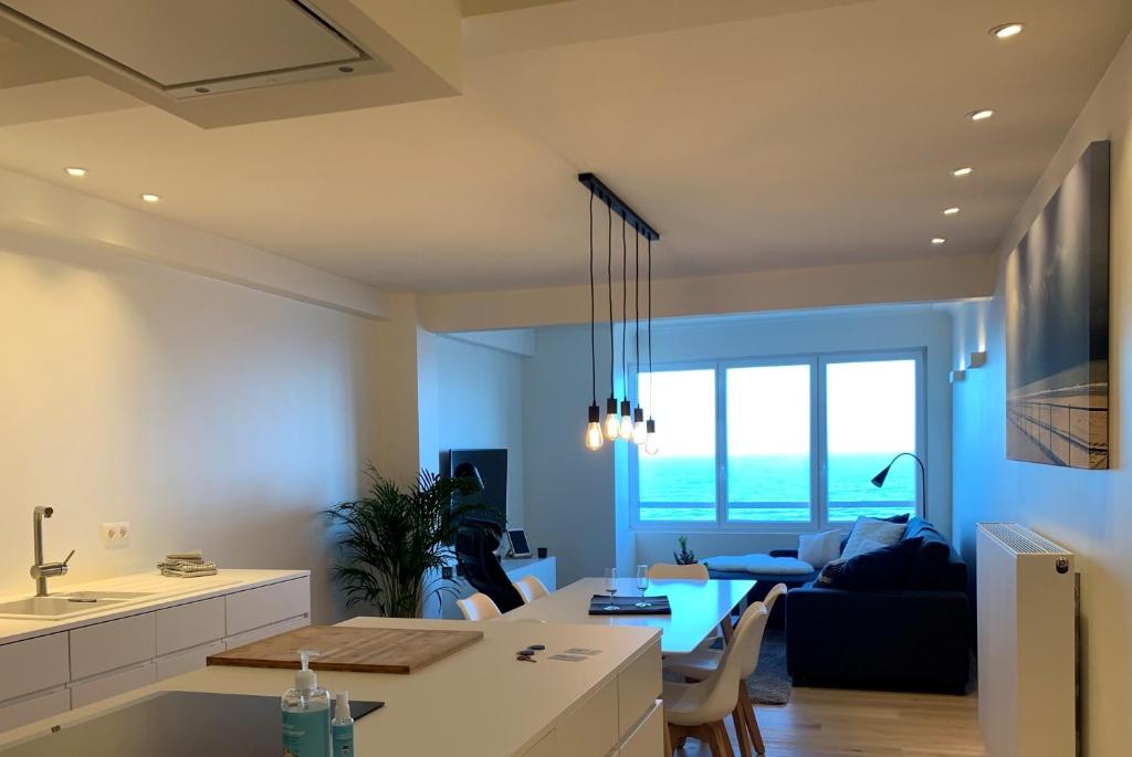 奥斯坦德OSKAR luxe appartement op zeedijk met zeezicht的厨房和客厅,享有海景