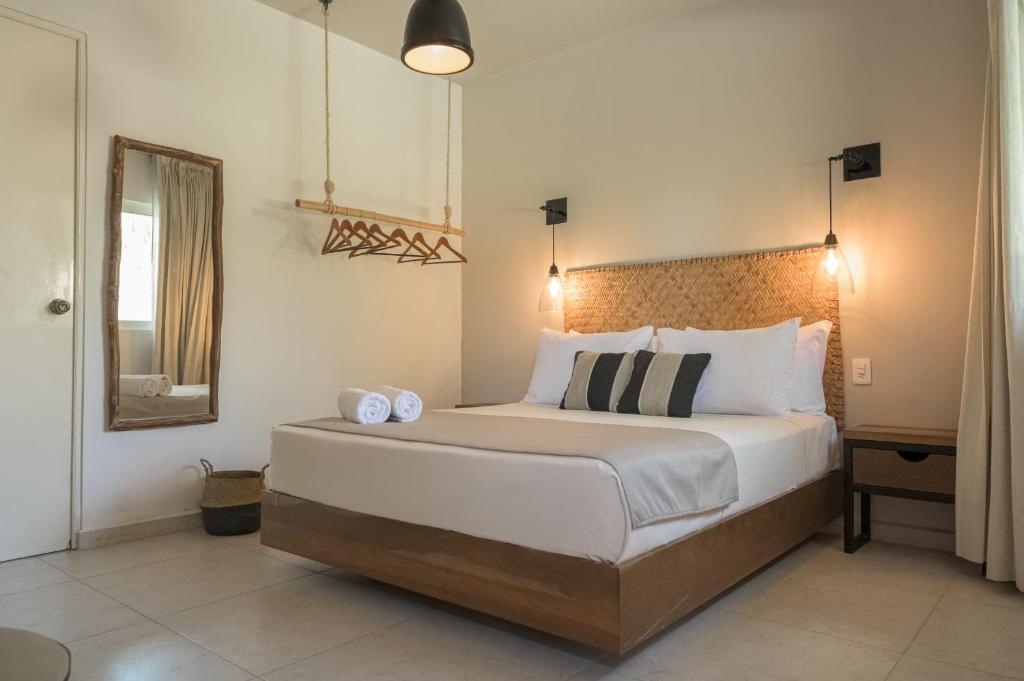 巴卡拉尔Agam Hotel的一间卧室配有一张大床和镜子