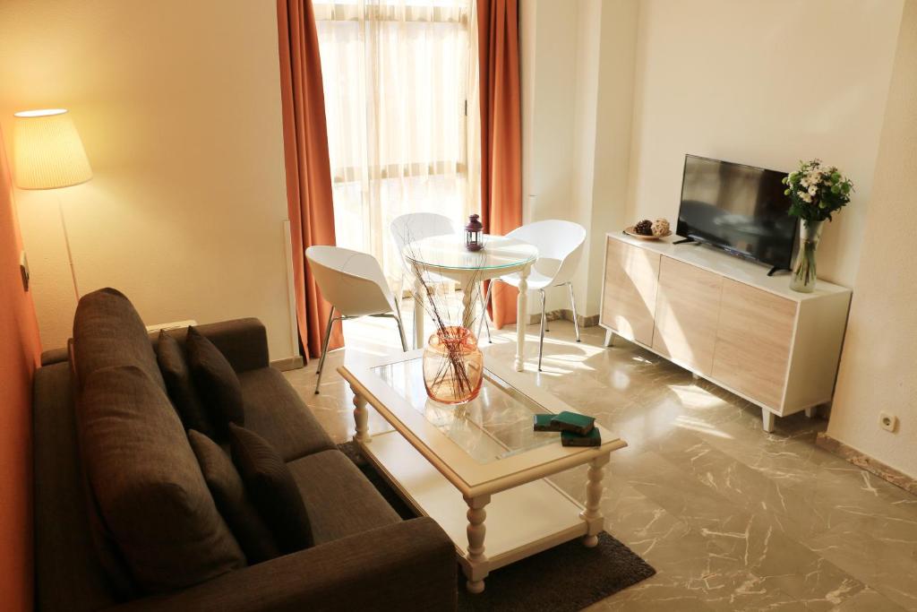 马德里佳利昂G3公寓酒店的客厅配有沙发和桌子