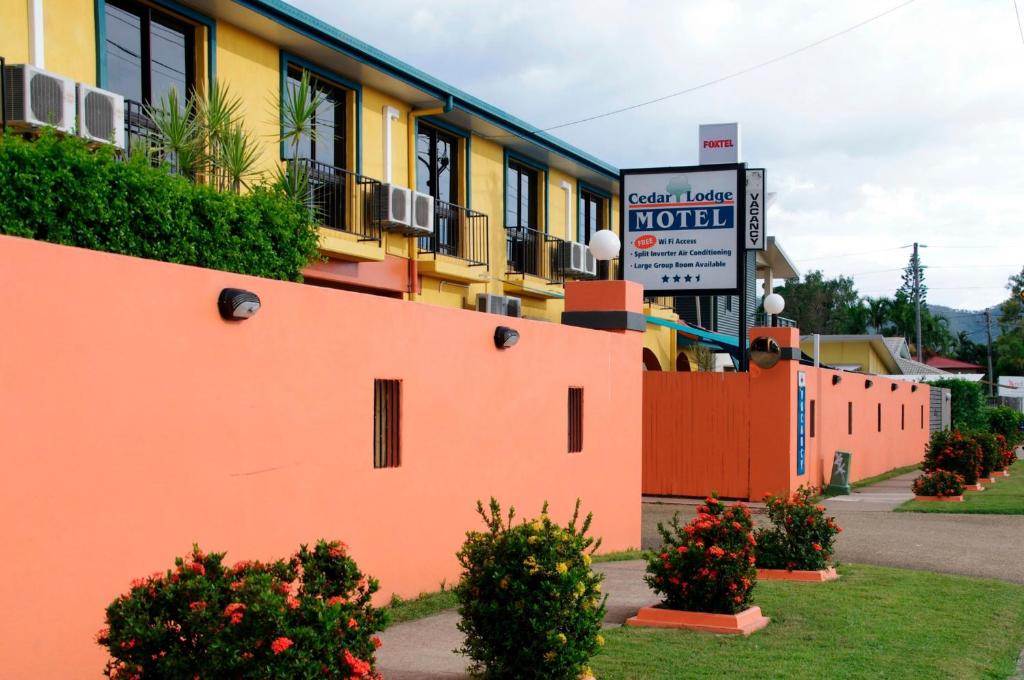 汤斯维尔思达汽车旅馆 的一座橙色的建筑,前面有汽车旅馆标志