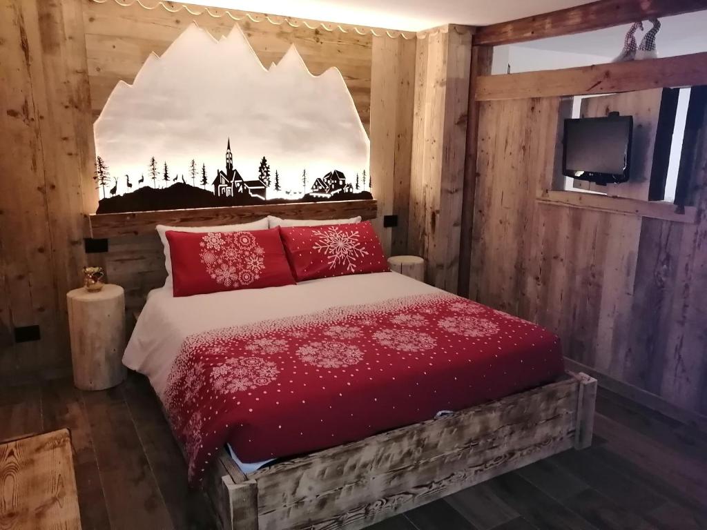 格雷桑Maison Perriail Vda Gressan n 0029的一间卧室配有红色枕头的床