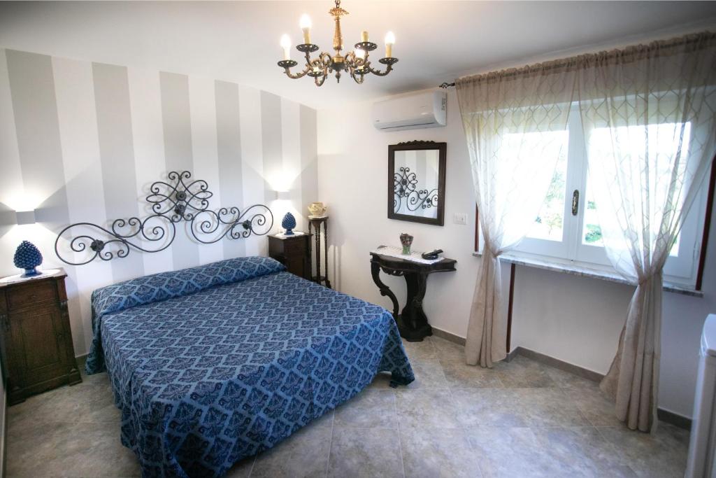 特罗佩阿Bed & Breakfast Elisabeth的一间卧室设有蓝色的床和窗户。