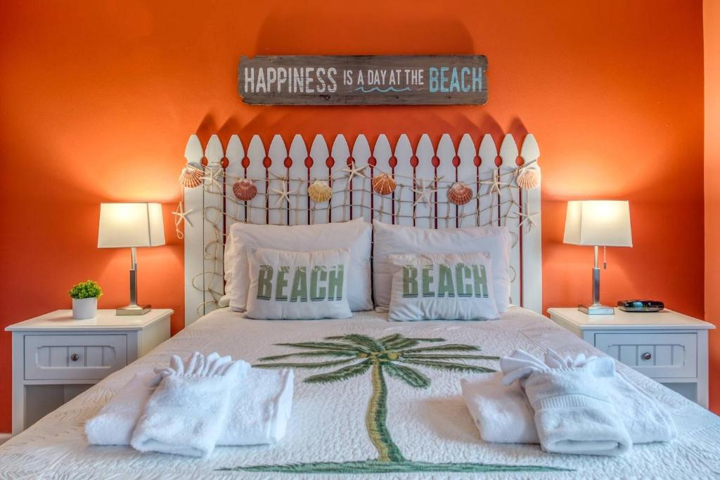 巴特勒海滩Driftwood Escape的一间卧室配有一张橙色墙壁的床