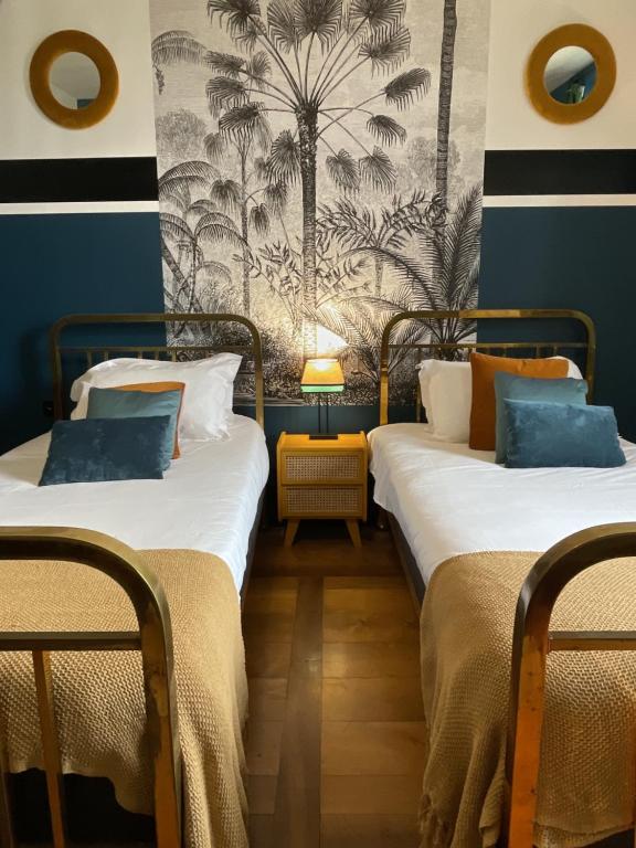 安锡布蒂克酒店的两张睡床彼此相邻,位于一个房间里