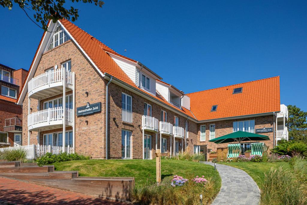 于斯德Heimathafen Juist的一座大型砖砌建筑,屋顶橙色