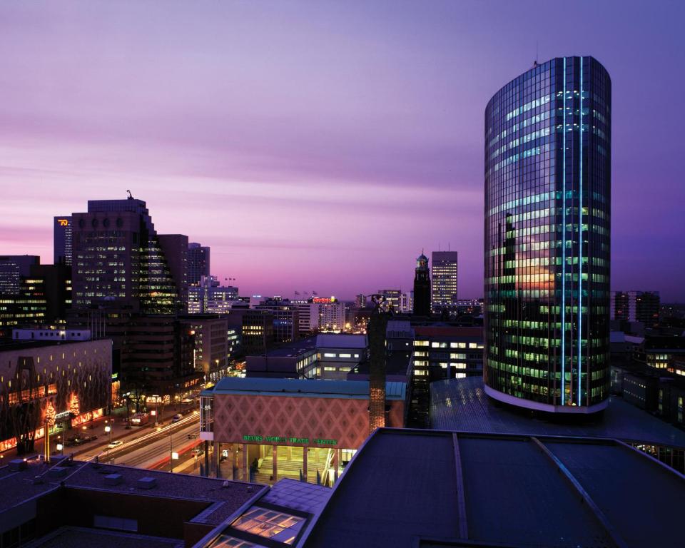 鹿特丹Postillion Hotel WTC Rotterdam的城市天际线,夜晚有高楼