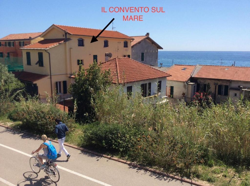 圣托·斯特凡诺·阿尔马尔Il Convento sul Mare的骑着自行车的人和一个沿着公路滑板的男孩