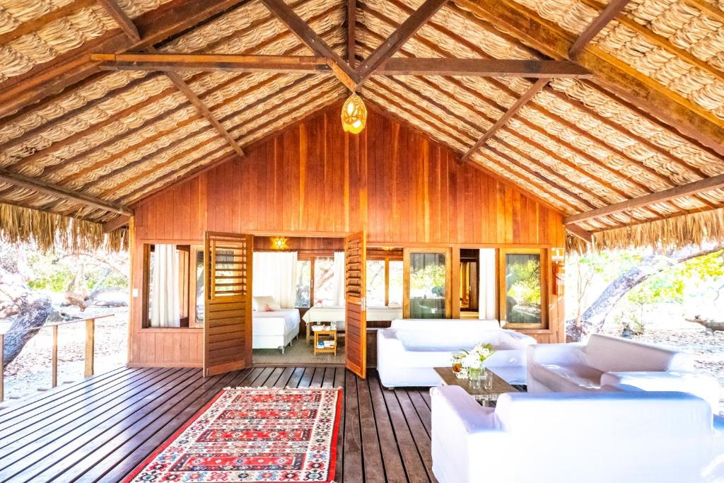 帕拉茹鲁Refugios Parajuru - Pavilhão的木屋配有白色家具和木制天花板