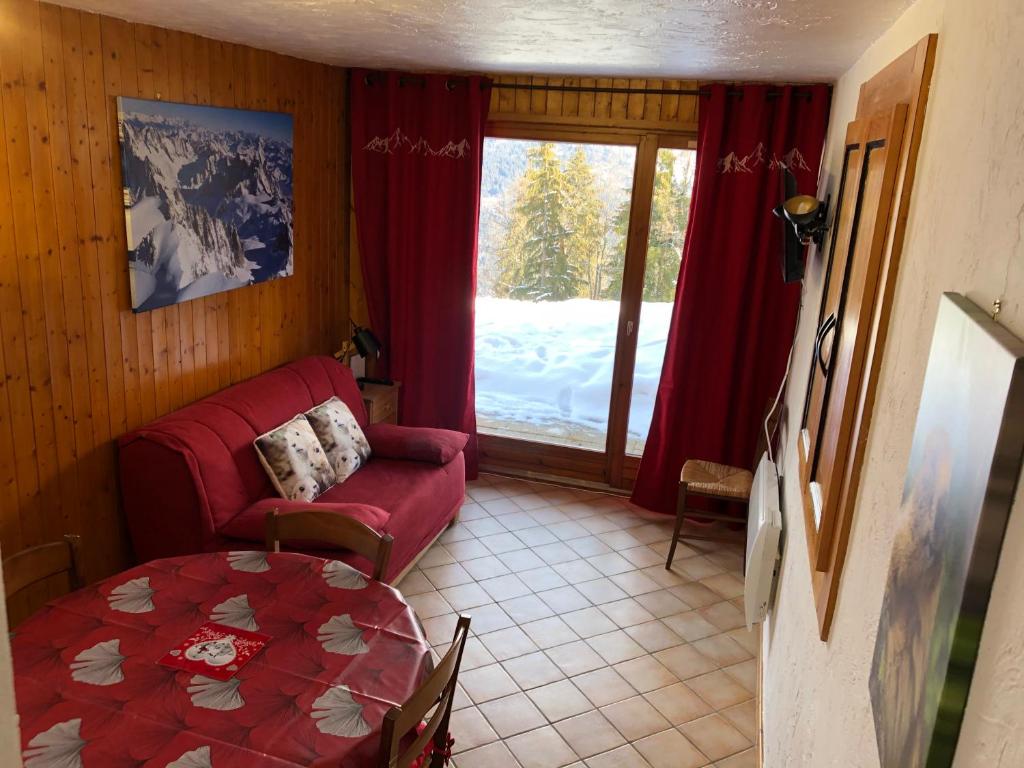 圣热尔韦莱班Petite Marmotte的客厅配有红色的沙发和桌子