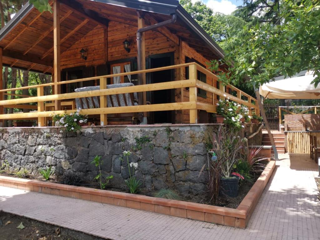 米罗Etna Baite Milo的小木屋设有石墙和门廊