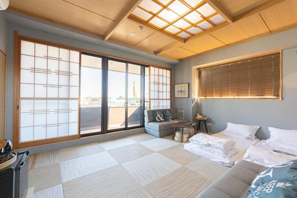 东京灯光旅館 Light hotel的客房设有床、沙发和窗户。