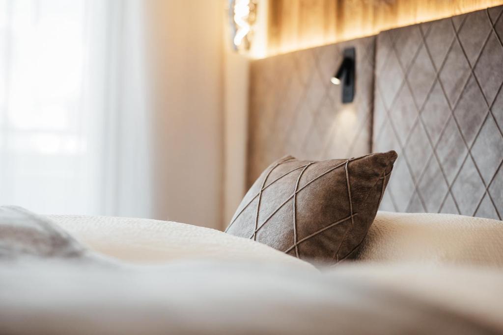 科瓦拉因巴迪亚Residence Villa Trieste的床上的棕色枕头