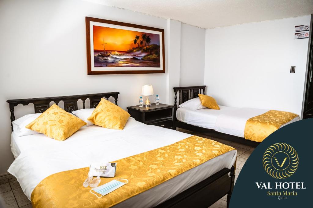基多Val Hotel Santamaria Quito的酒店客房 - 带两张带黄色枕头的床