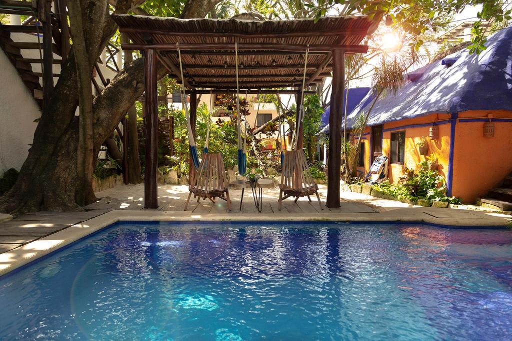 莫雷洛斯港阿马尔酒店的一个带椅子的游泳池和一个凉亭