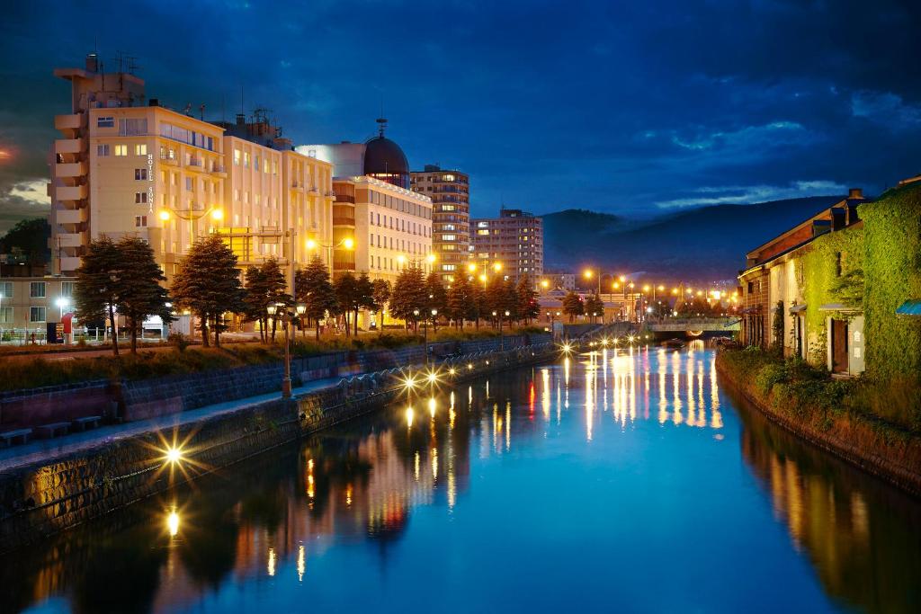 小樽Sonia 小樽酒店的城市的河流,夜晚有建筑物