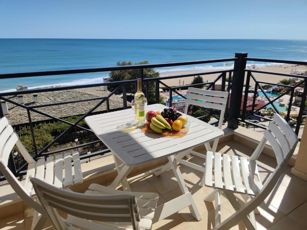 金沙Europroperties Sirena Apartaments的海滩阳台的白色桌椅