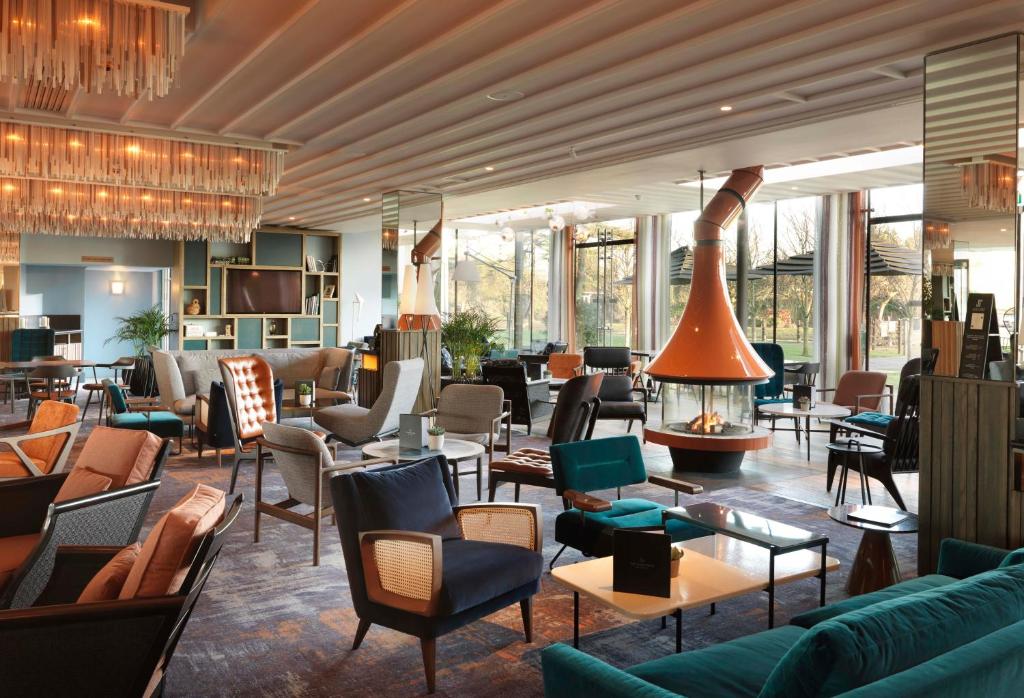 埃格姆泰晤士河拉尼米德酒店的大堂配有沙发、椅子和壁炉
