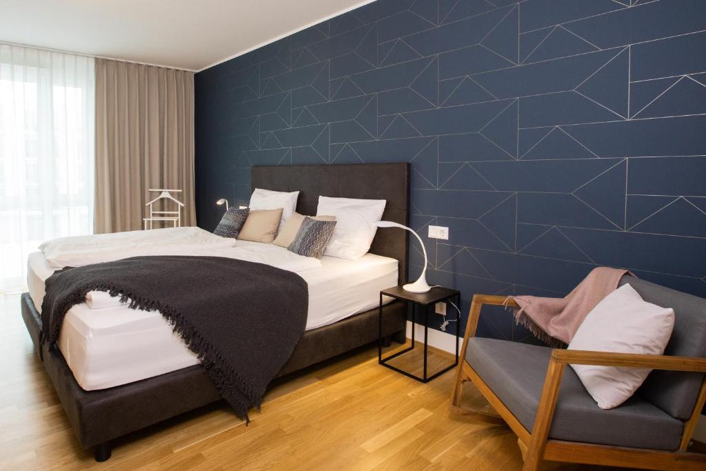 腓特烈港Ferienwohnung Pfänder的一间卧室设有一张床和蓝色的墙壁