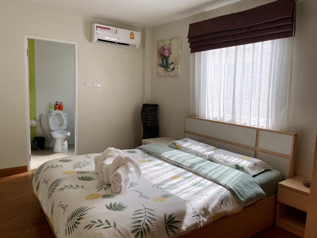 曼谷曼谷TD酒店的一间卧室配有带毛巾的床