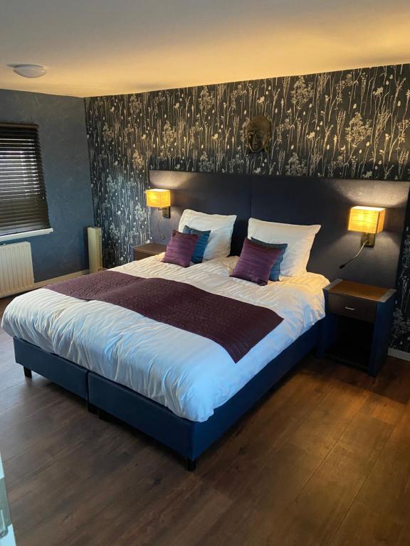 Oude WeteringAppartement Aqua的一间卧室配有一张带紫色枕头的大床