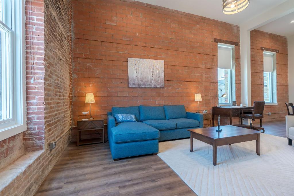 加尔维斯敦Meilleur的客厅设有蓝色的沙发和砖墙