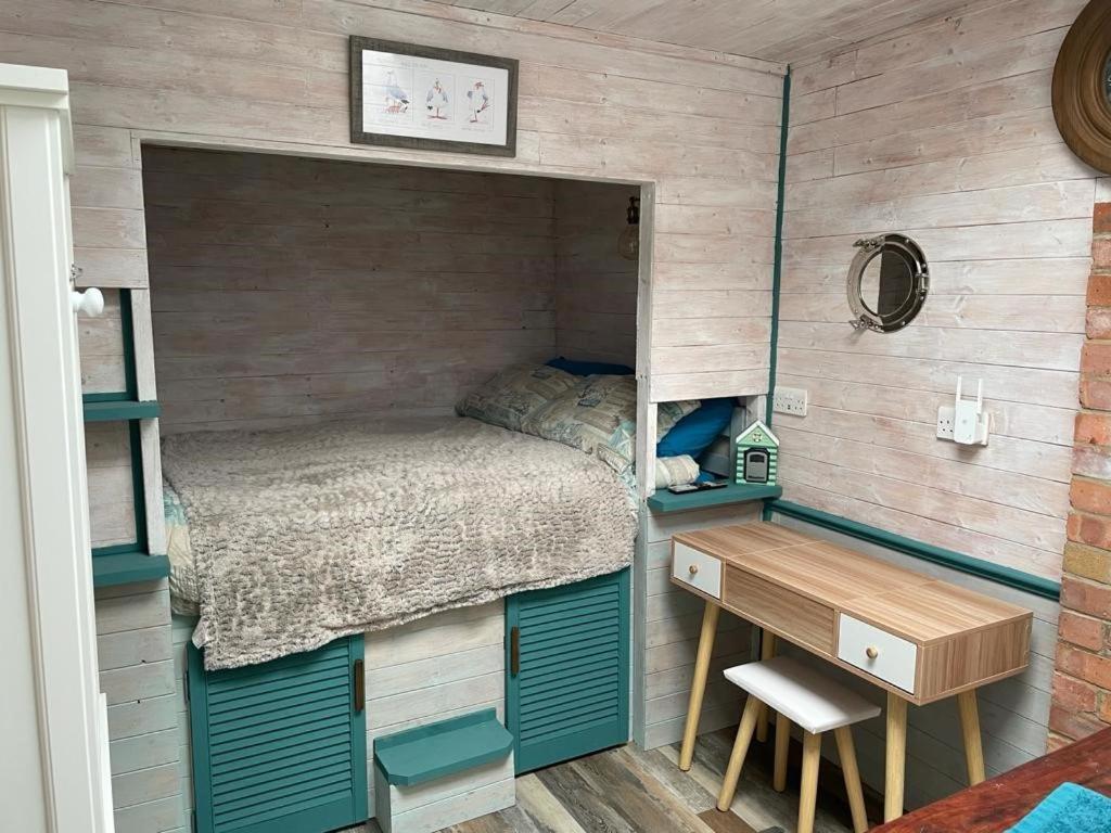 SaltdeanThe Old Garage的一间小卧室,配有一张床和一张书桌
