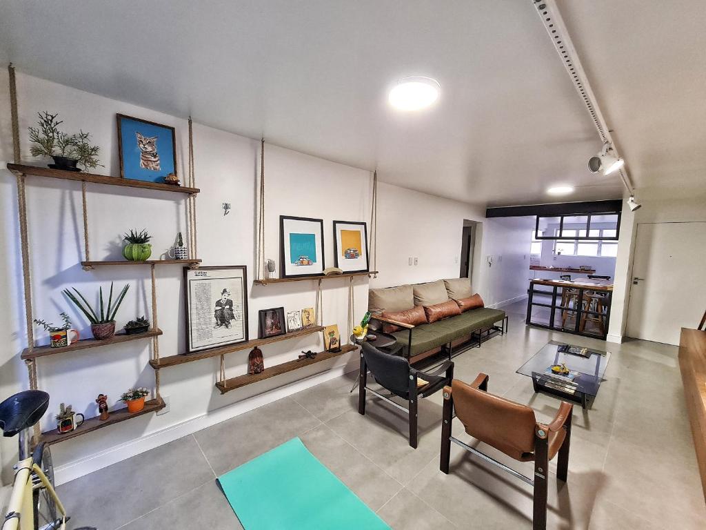 本图贡萨尔维斯Apartamento Artístico - Garagem - Ar Condicionado - Excelente Localização的客厅配有沙发和桌子