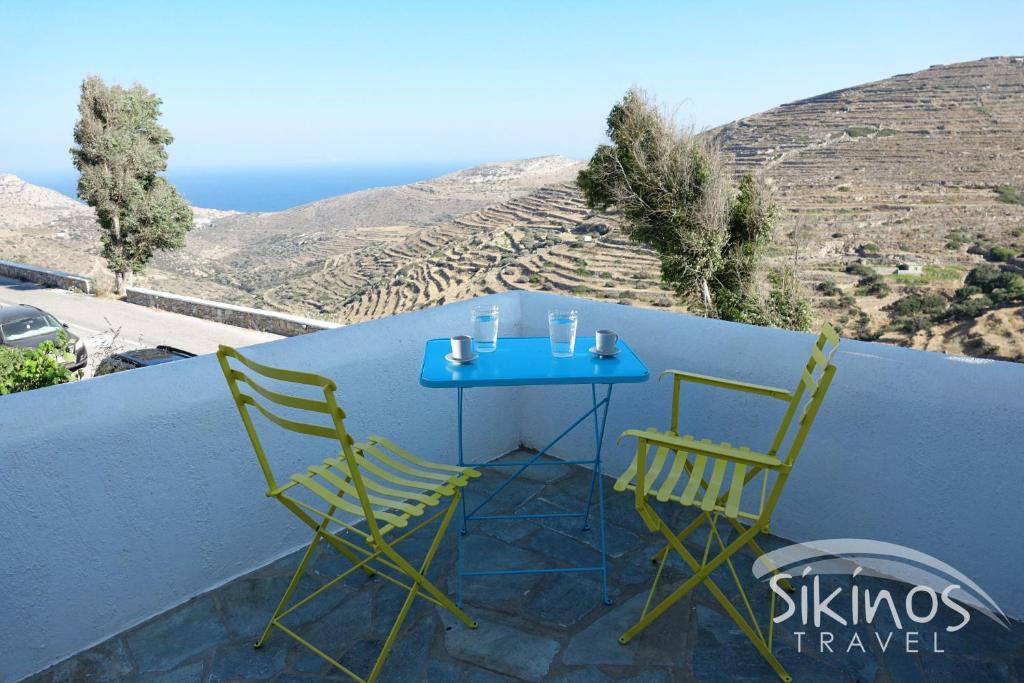锡基诺斯岛Sikinos Elegant Studio的阳台配有一张蓝色的桌子和两把椅子