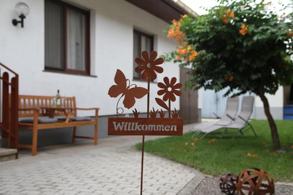 伊尔米茨Ferienwohnung Illy的花在房子前面的标志