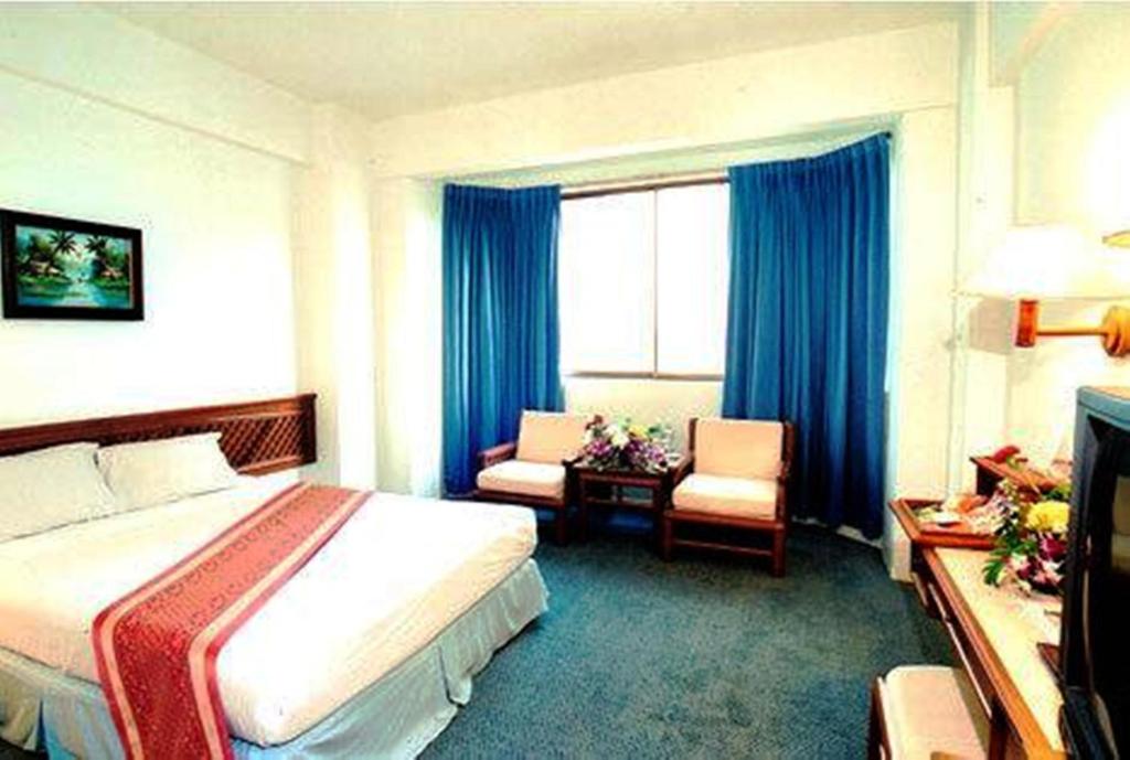 合艾合艾丽景湾酒店的配有一张床和一把椅子的酒店客房