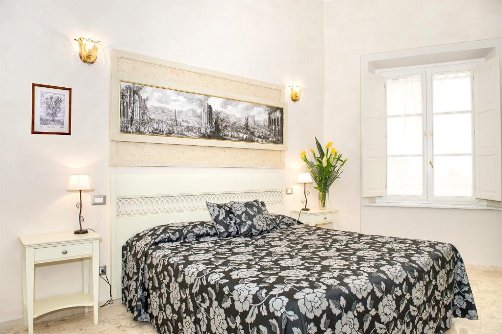 比萨里莱斯戴梅坎蒂套房住宿加早餐酒店的卧室设有黑白床和窗户。