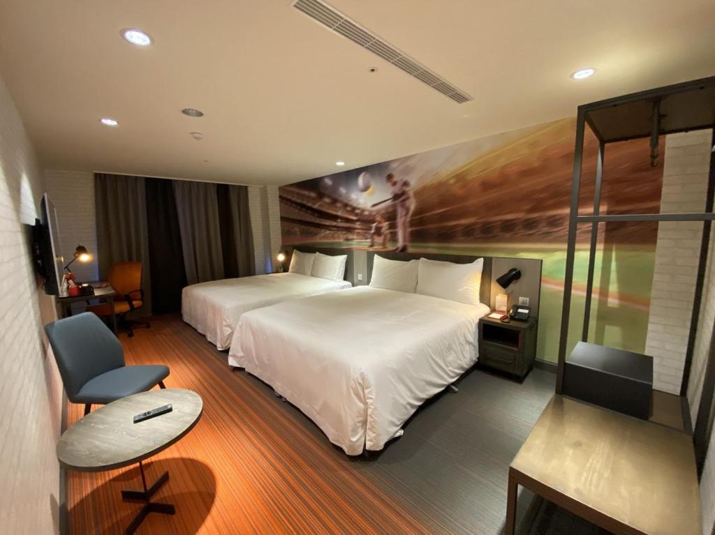 后里丽宝赛车主题旅店的酒店客房设有一张大床和一张书桌。