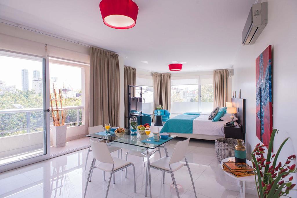 布宜诺斯艾利斯Soho Luxury Suites的卧室配有一张床和一张桌子及椅子