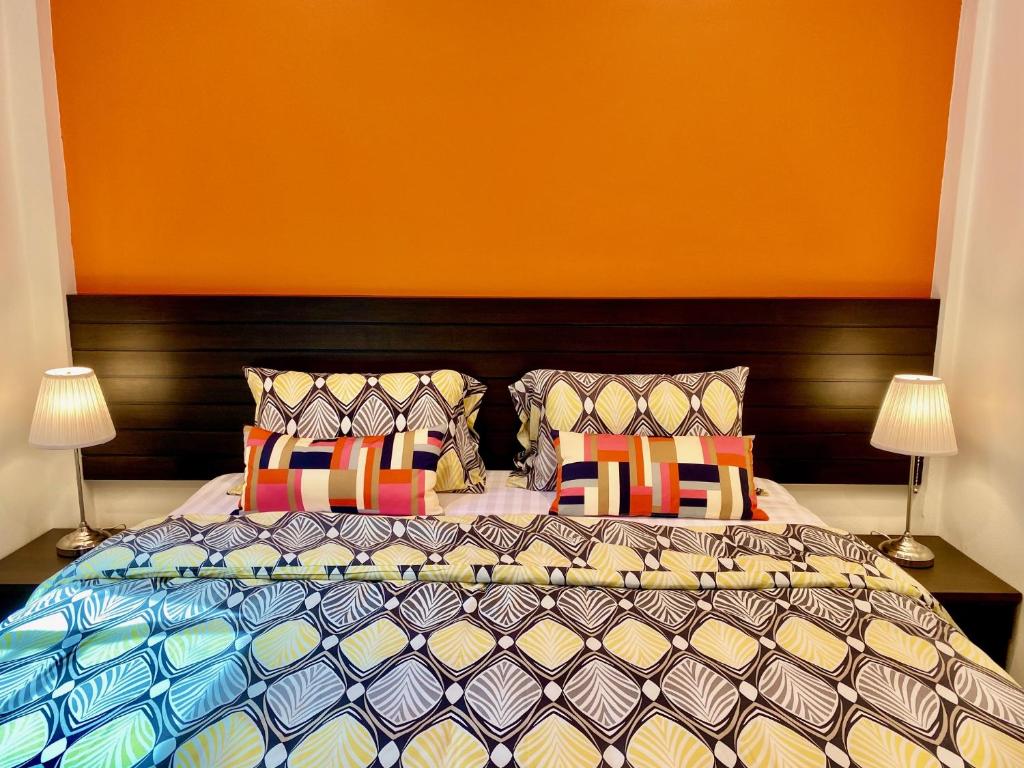 高兰YinDee Lanta Villas的一间卧室配有一张带色彩缤纷枕头的大床