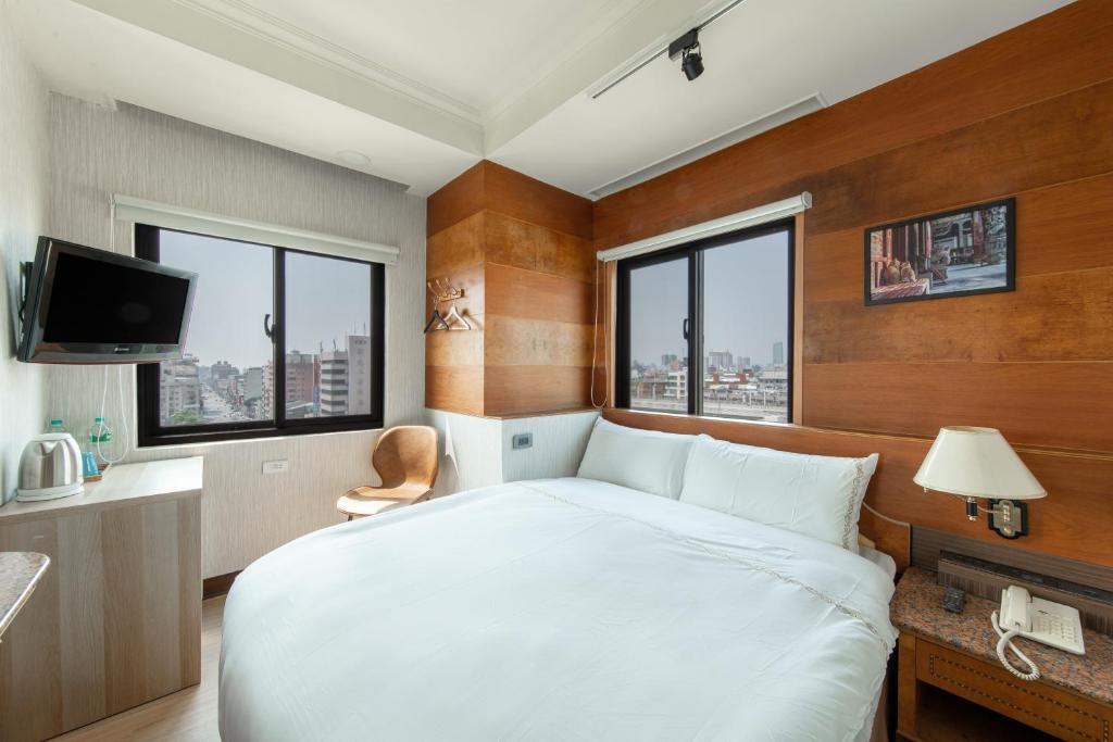 台中市二川行旅 - HiRiver Hotel的卧室设有白色大床和窗户。