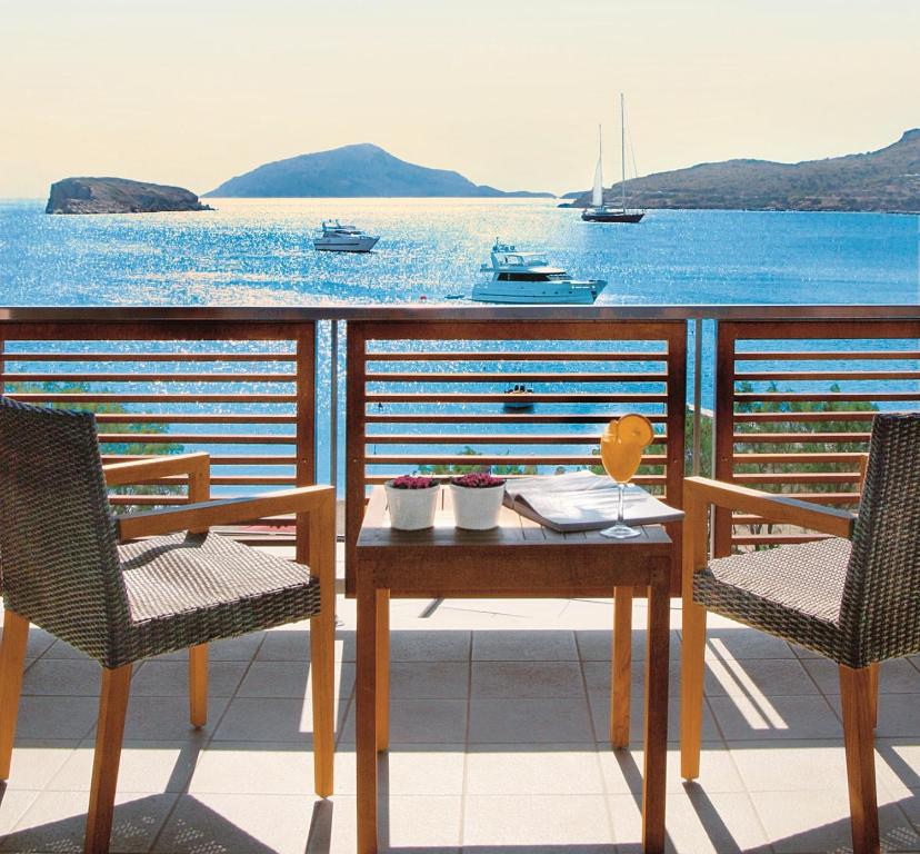 苏尼翁爱琴海岸酒店的海景阳台上的桌椅